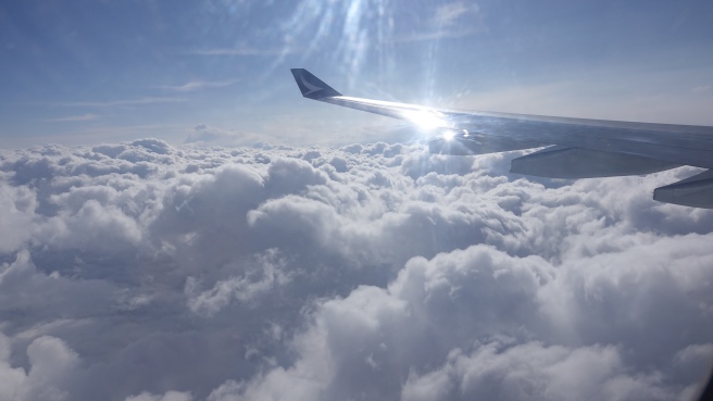 the wing of an airplane above the clouds