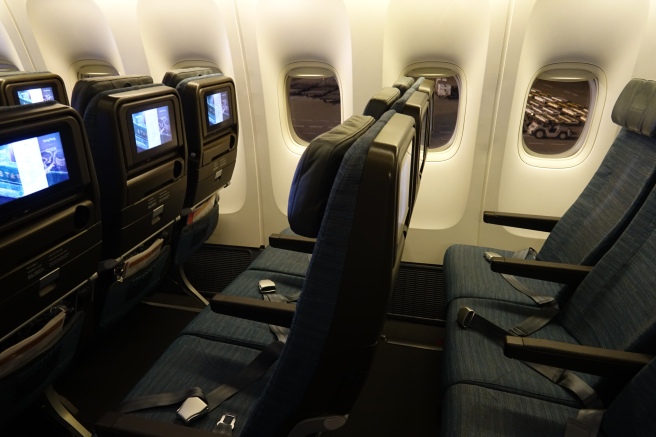 seats in an airplane with monitors