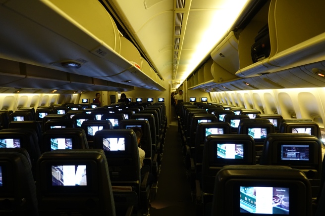 an airplane with rows of seats and monitors