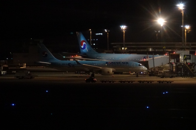 airplanes at an airport at night