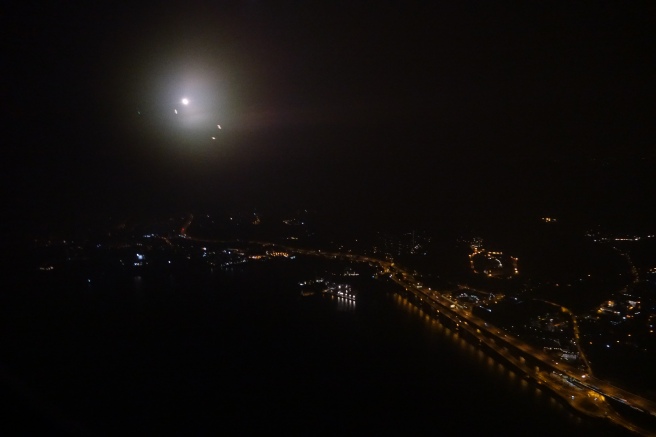 a city at night with a bridge and lights