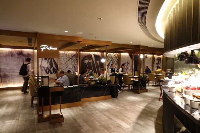 a group of people sitting at tables in a restaurant