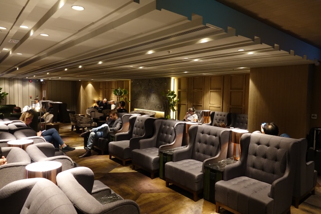 a group of people sitting in a room with chairs