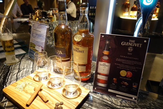 a group of bottles of alcohol and glasses on a table