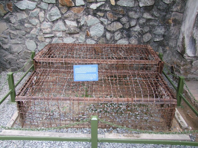 a metal cage with a sign on it
