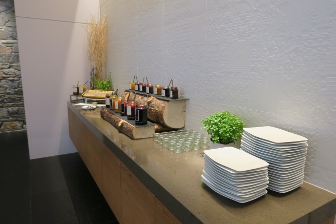 a buffet table with plates and jams