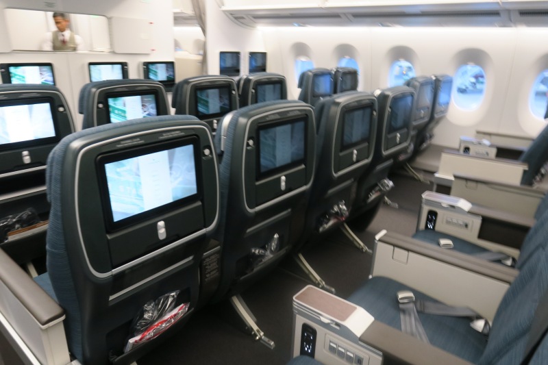 a row of seats with monitors on the back