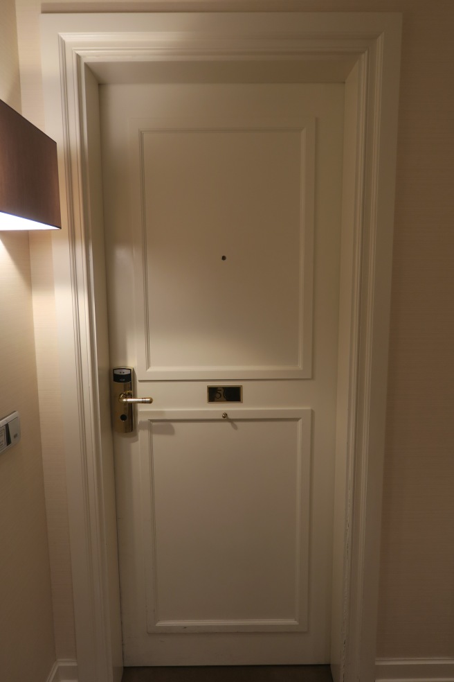 a white door with a gold handle