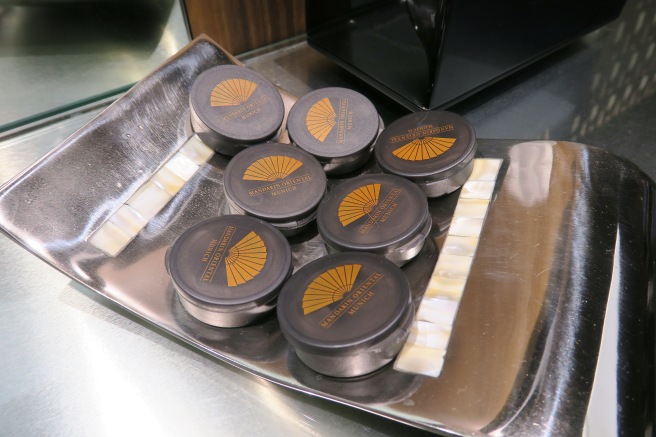 a group of round black objects on a silver tray