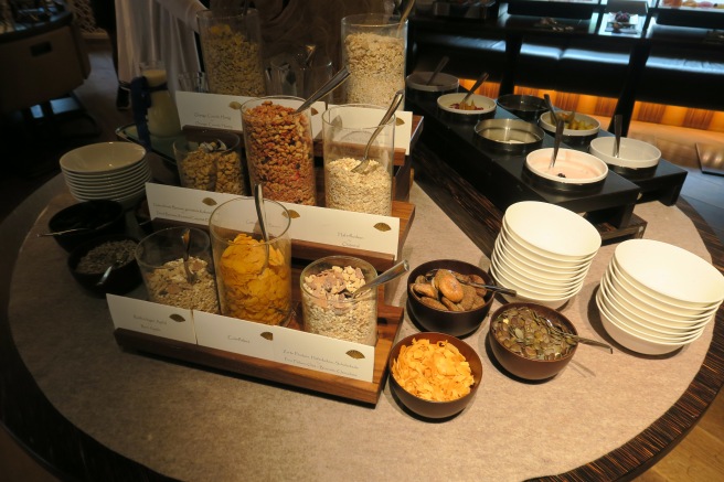 a table with bowls of cereal and cereals