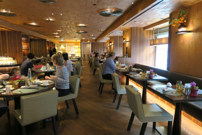 people sitting at tables in a restaurant