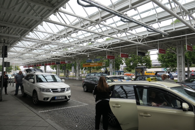 a woman standing in front of a car