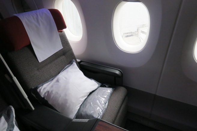 a seat with a pillow and two oval windows