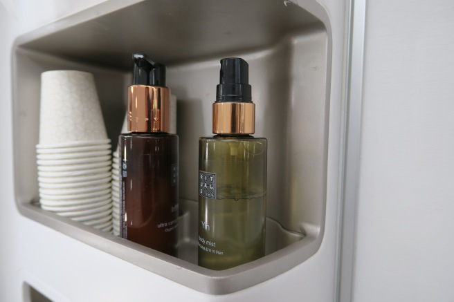 bottles and cups in a shelf