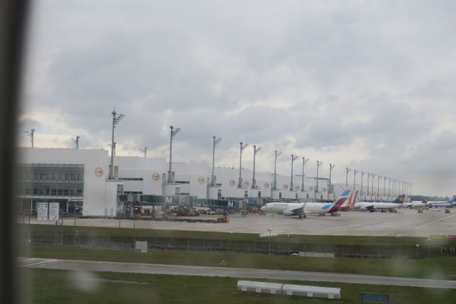 a group of airplanes parked at an airport