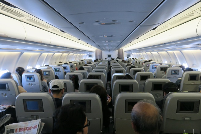 a group of people sitting in an airplane