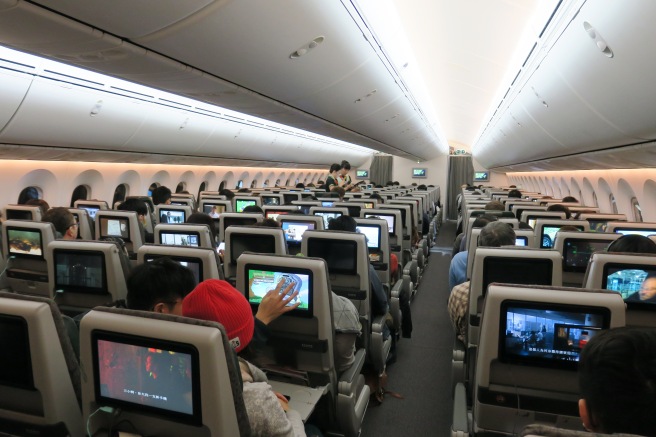 a group of people sitting in an airplane