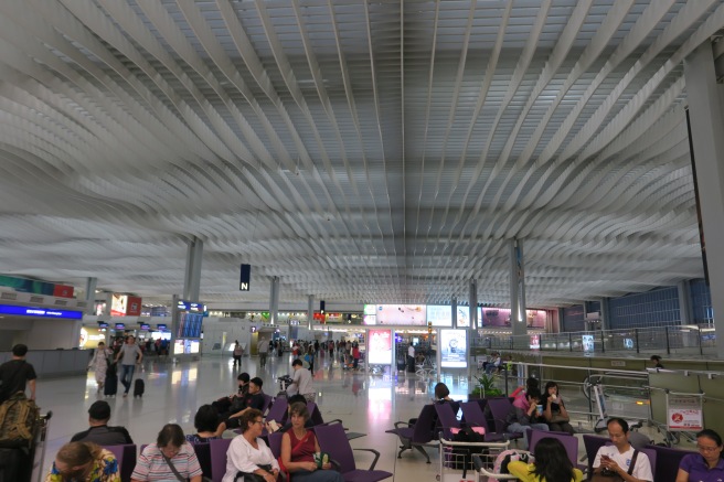 people sitting in a large airport