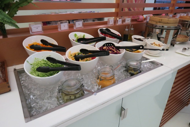 a buffet line with bowls of food