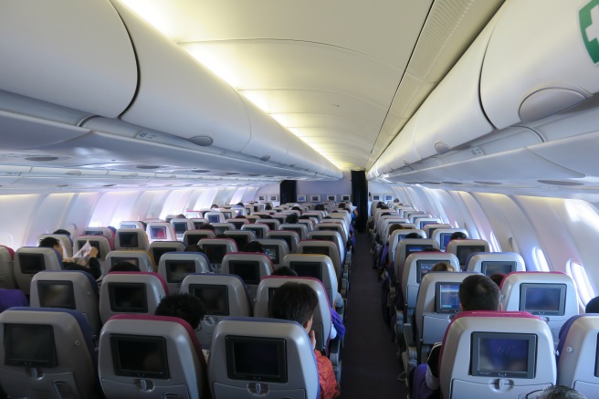 a group of people sitting in an airplane