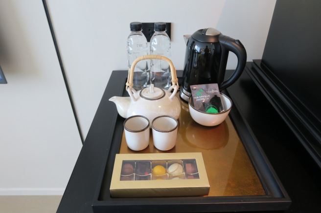 a tray with teapot and cups and a coffee pot