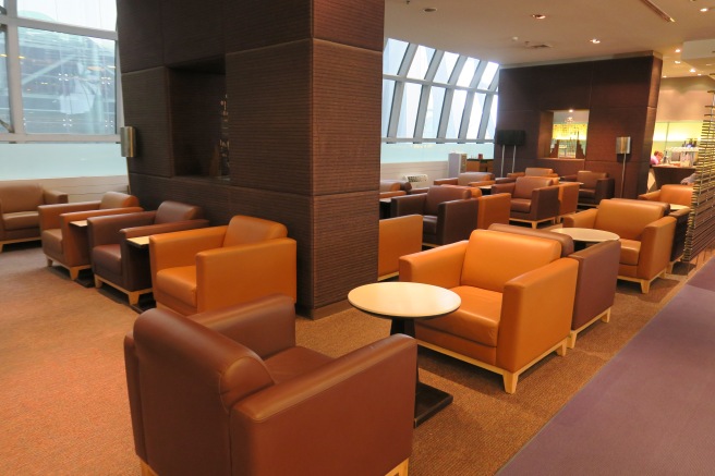 a lounge area with chairs and tables