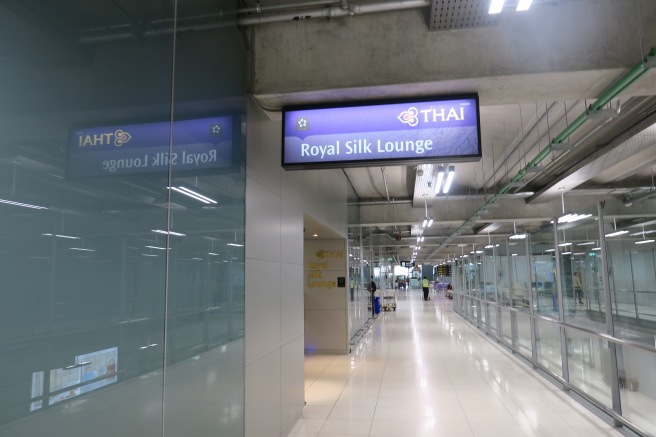 a long hallway with a sign