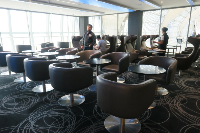 a group of people in a room with chairs and tables