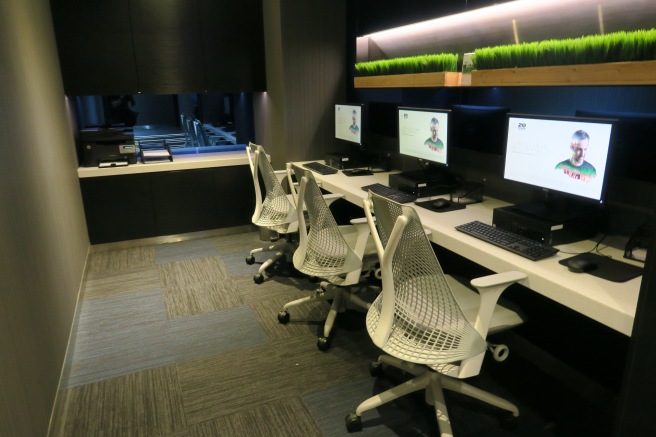 a room with computers and chairs