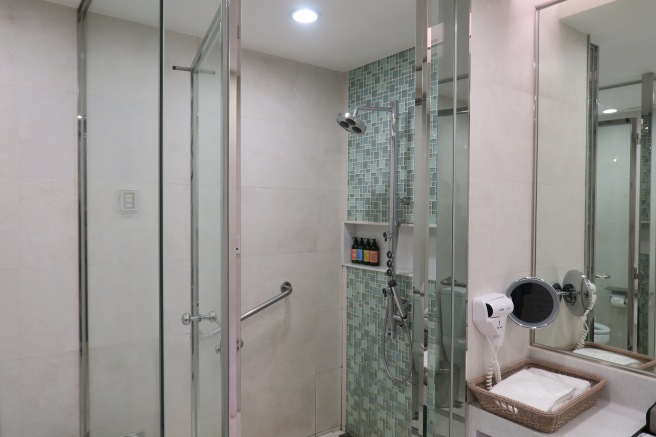 a bathroom with a shower and sink