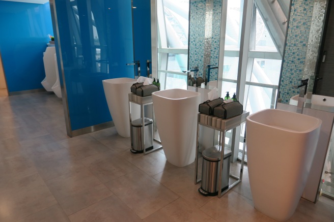 a bathroom with sinks and blue wall