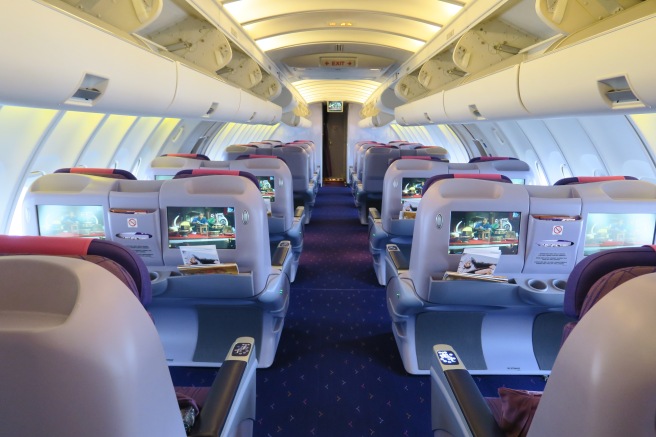 the inside of an airplane with rows of seats