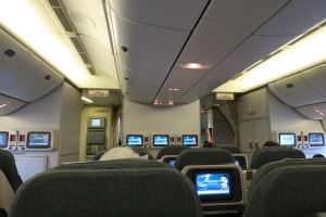 a row of seats with monitors on the back