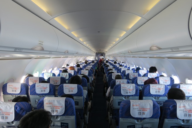 a group of people sitting in an airplane