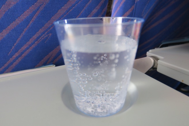 a glass of water on a tray