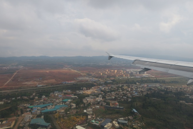 an airplane wing and a city