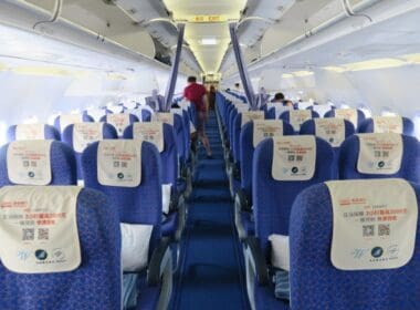 a row of blue seats on an airplane