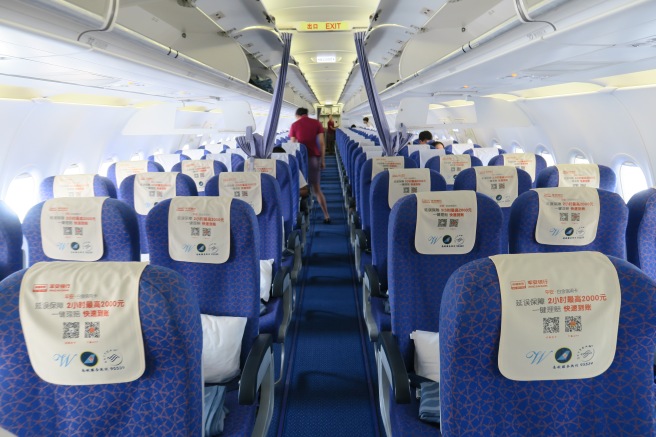 a row of blue seats on an airplane