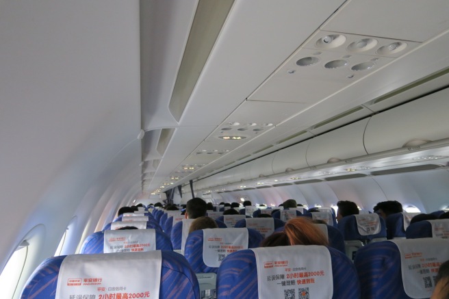 a group of people sitting on an airplane