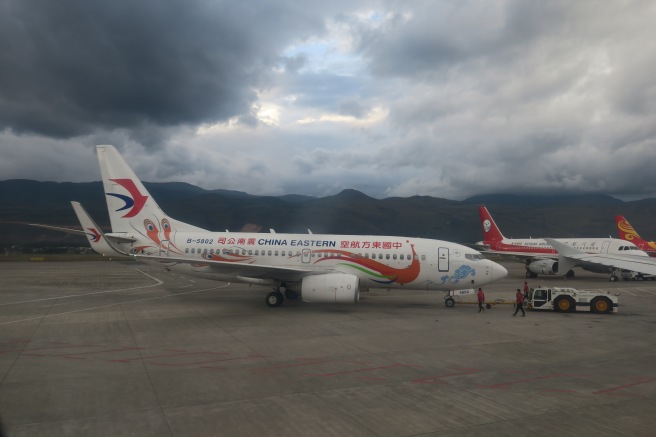 a group of airplanes on a runway