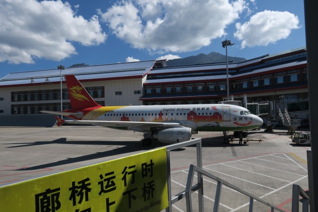 a plane parked in front of a building