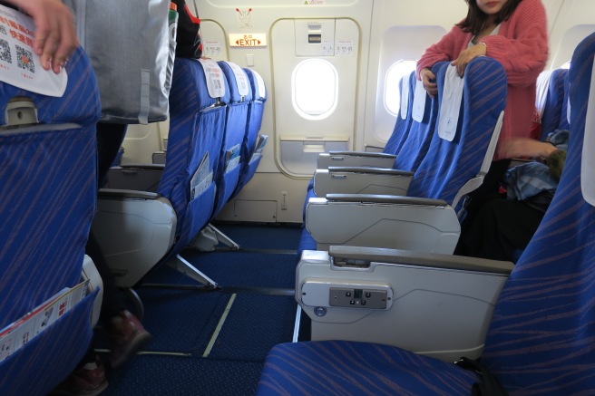 a group of people standing in an airplane