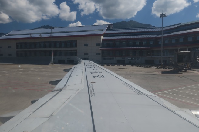 an airplane wing in front of a building