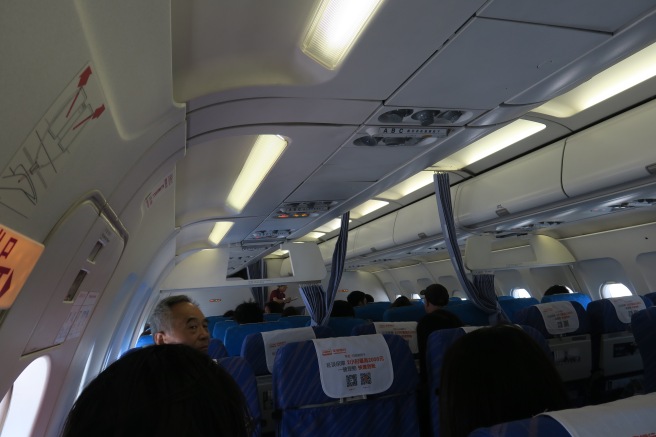 a group of people sitting in an airplane