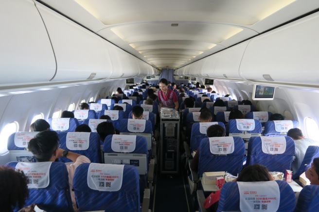 a group of people sitting in an airplane