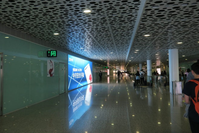 a large hall with people walking