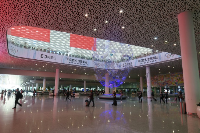 a large hall with people walking