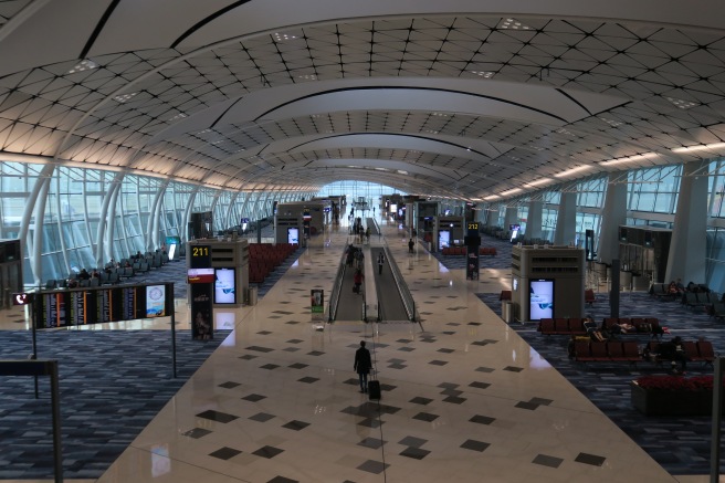 a large airport with people walking in the middle