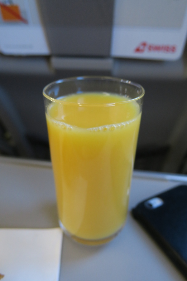 a glass of orange juice on a table