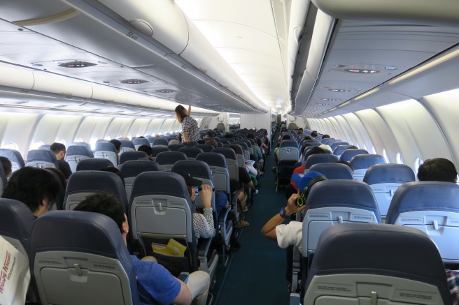 a group of people sitting in an airplane